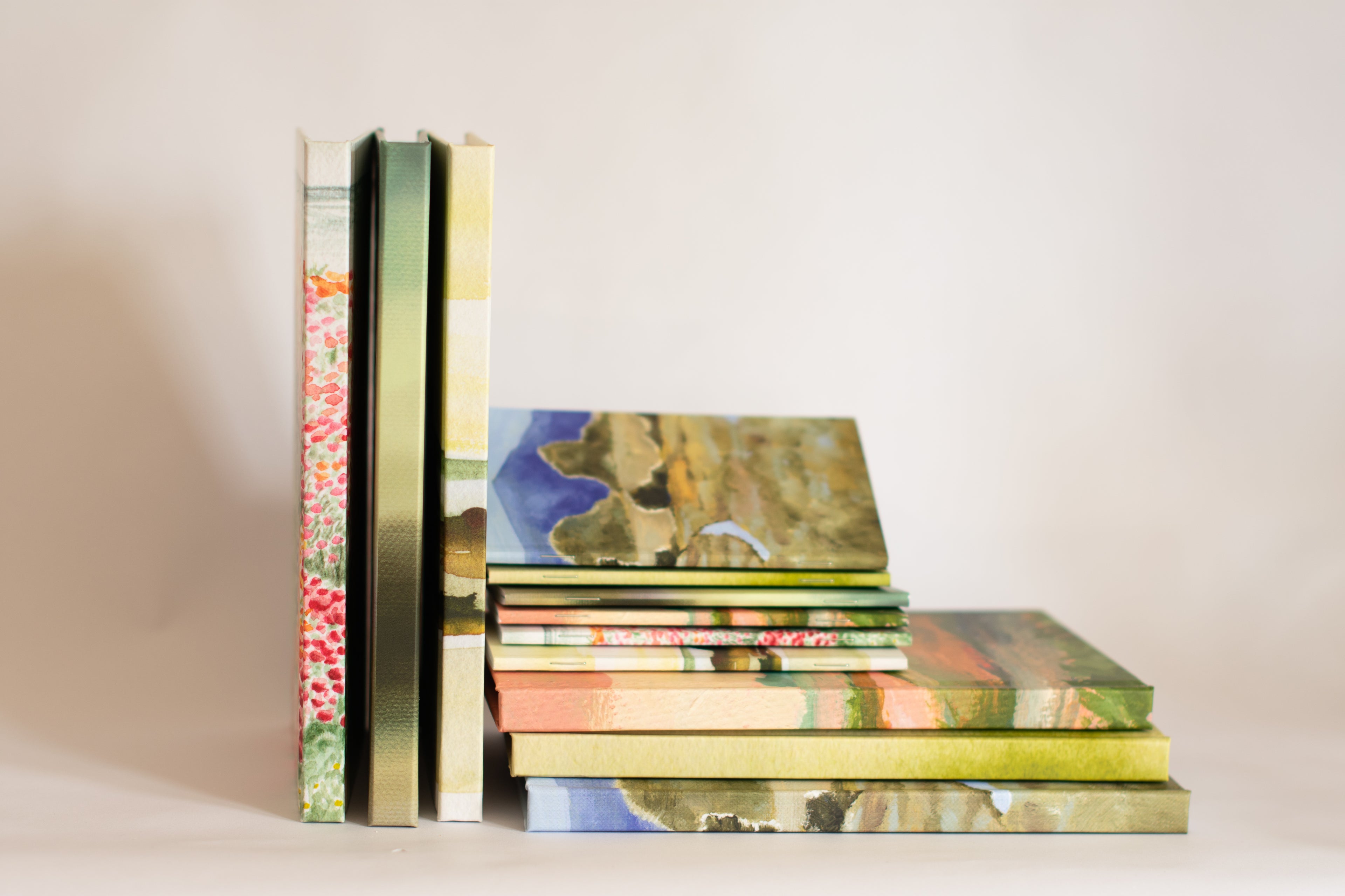 Stack of books with colorful covers on a plain background