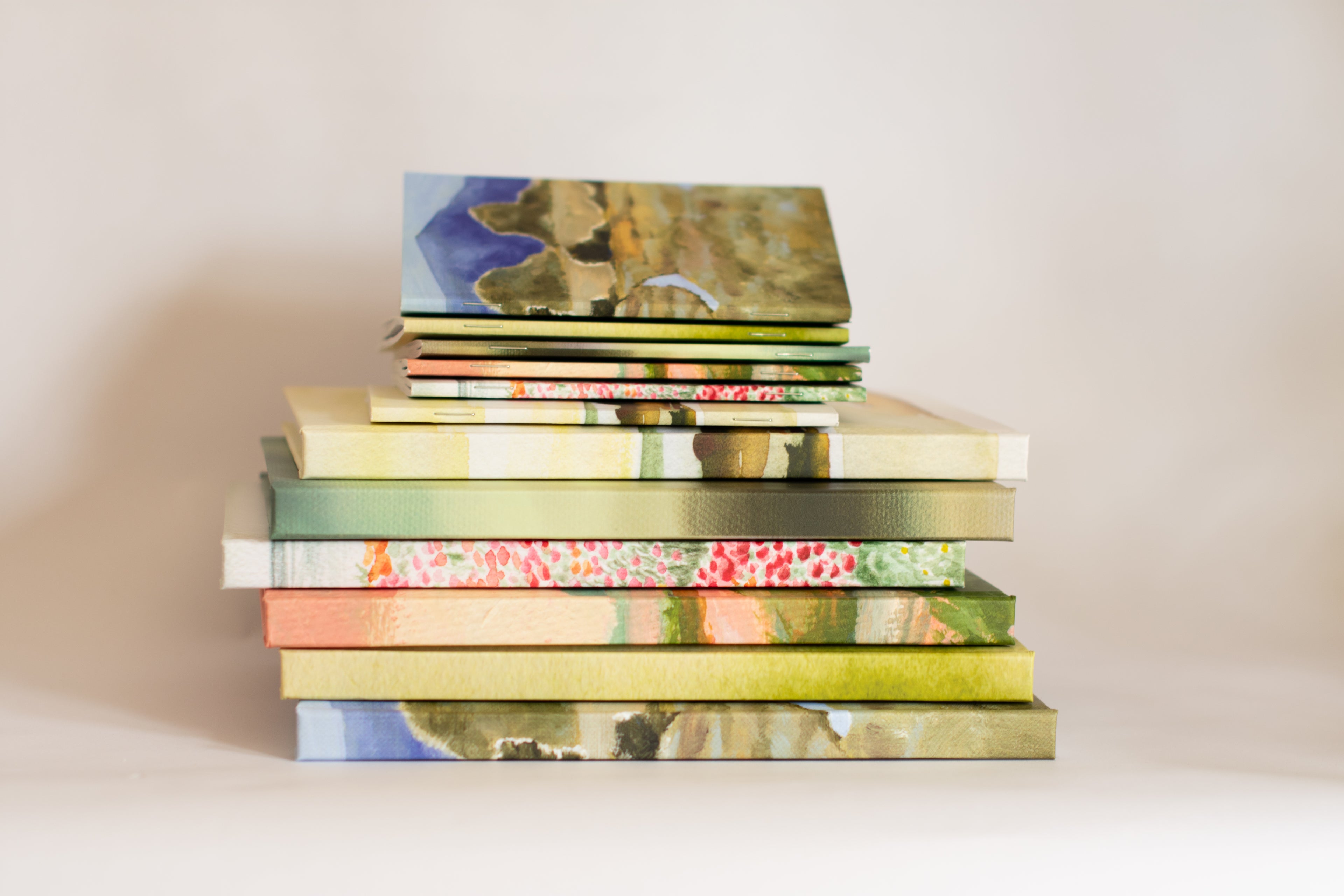 Stack of books with colorful covers on a light background