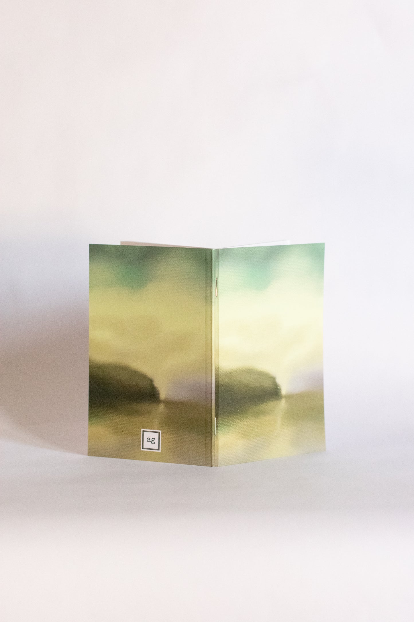 Folded notebook with a scenic design on a white background