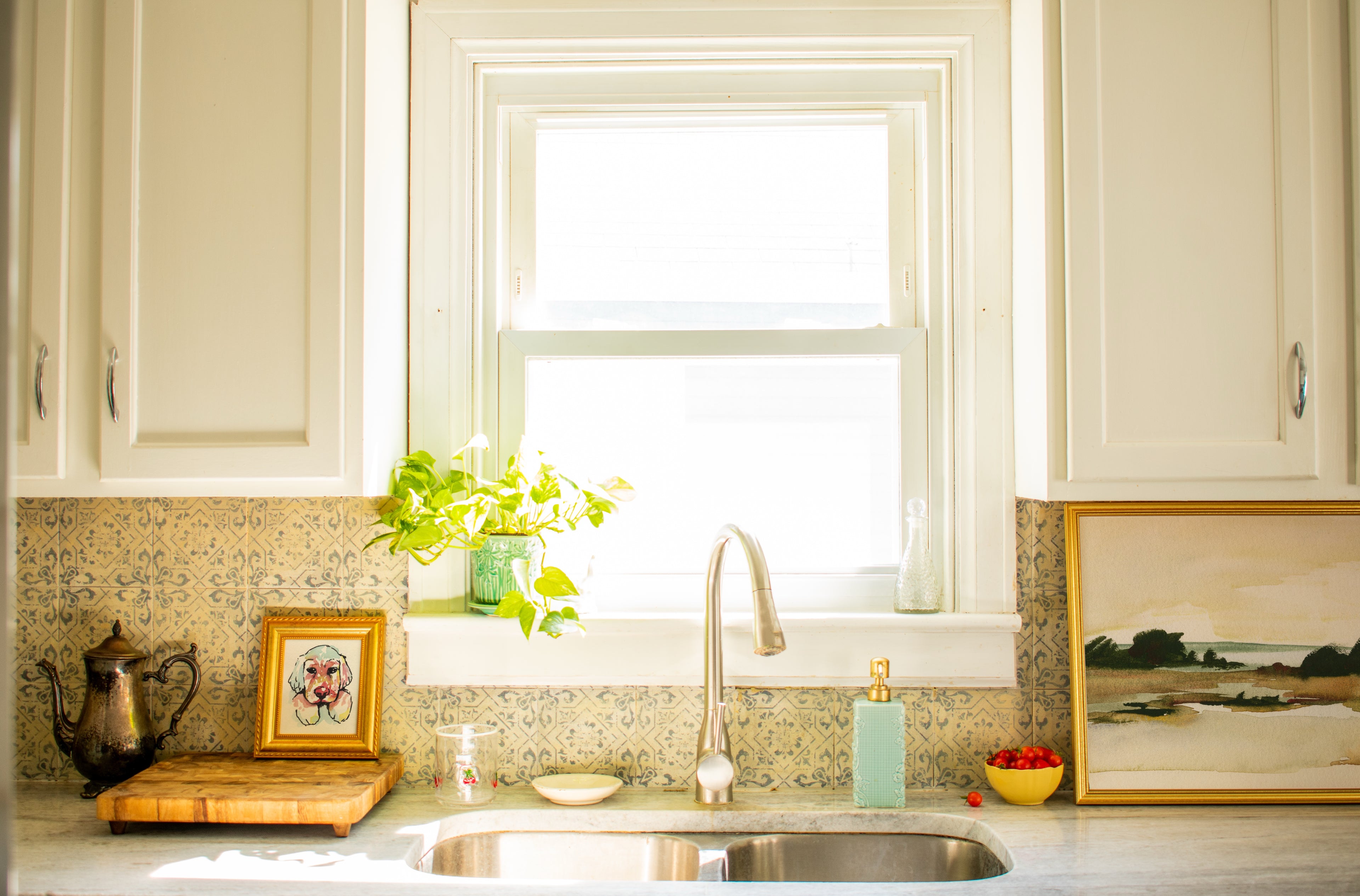Kitchen with sink, window, and decorative elements